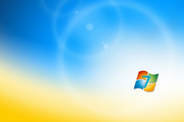 Логотип microsoft windows 7на размытом фоне напоминающем пшеничное поле и небо
