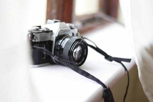 Камера canon стоит на подоконнике