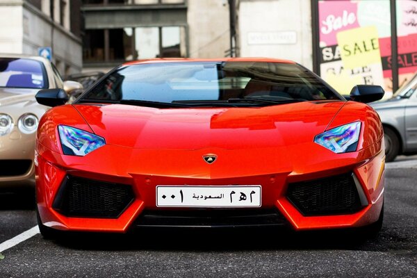 Lamborghini pomarańczowy samochód z arabskimi numerami