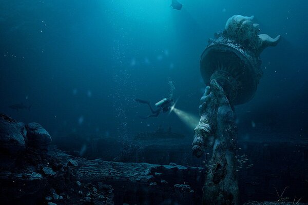 Płetwonurek bada ocean. Statua na dnie morza