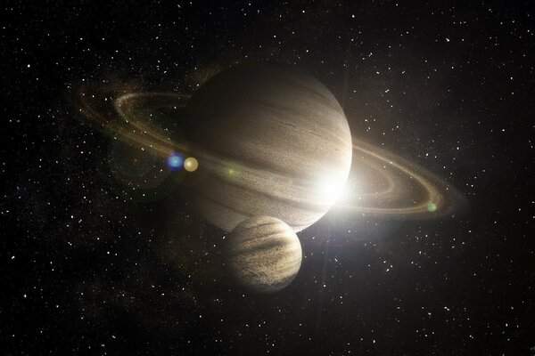 Saturn ze swoim księżycem na tle gwiazd